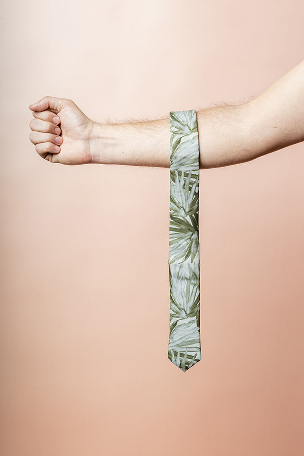 Chic cotton tie in sage with a detailed fan palm leaf pattern, perfect for adding a touch of the tropics to formal wear