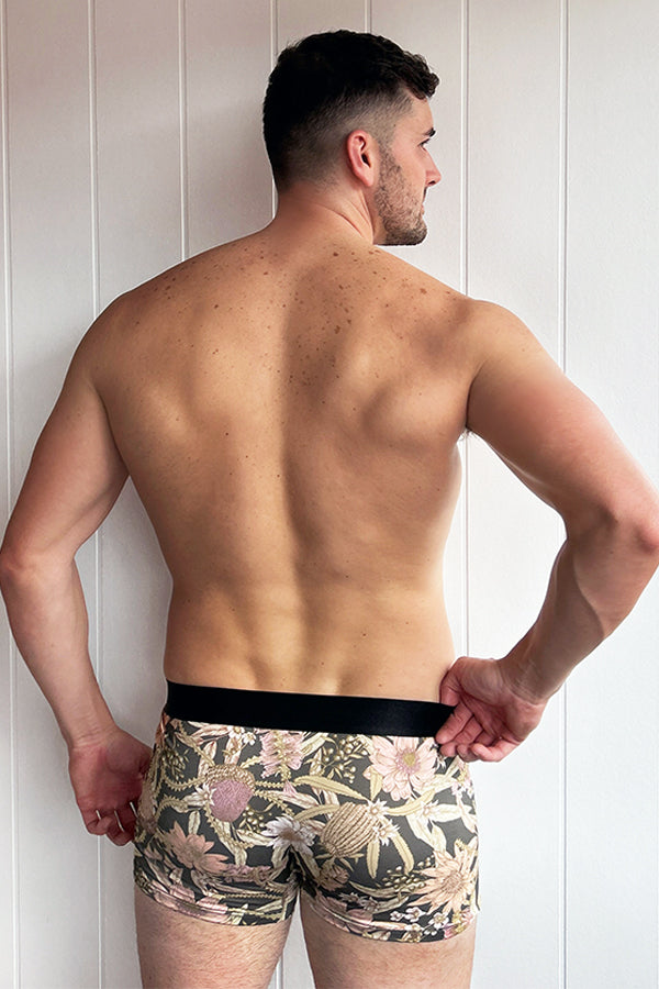 Comfortable bamboo underwear with a botanical print inspired by Australian native flowers on a dark background