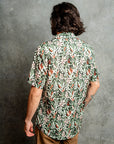 Relaxed fit shirt with Protea floral pattern in shades of green, orange, and white