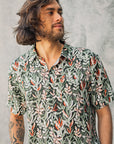 Men's short sleeve shirt featuring a Protea print on a green background