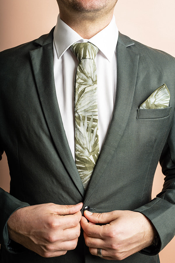 Chic cotton tie in sage with a detailed fan palm leaf pattern, perfect for adding a touch of the tropics to formal wear