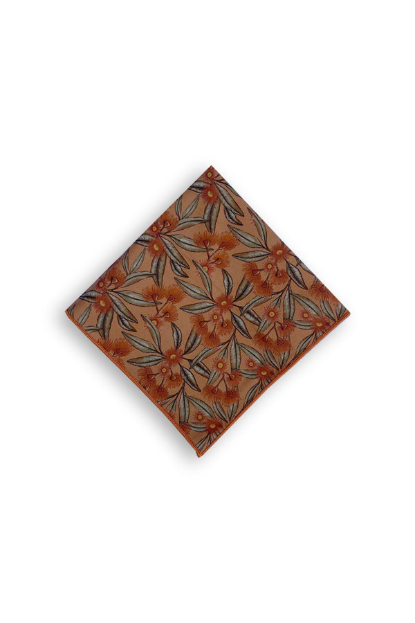 Stylish 100% cotton pocket square with a flowering gum design in terracotta, perfect for adding a pop of natural color and sophistication to any suit